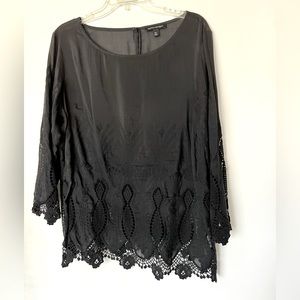 Women’s 3/4 sleeve top with lace like sleeves and hem. Thin fabric